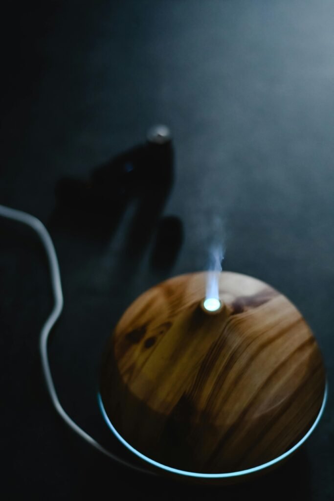 Elegant wooden diffuser releasing steam, perfect for aromatherapy indoors. Creates a calming atmosphere.
